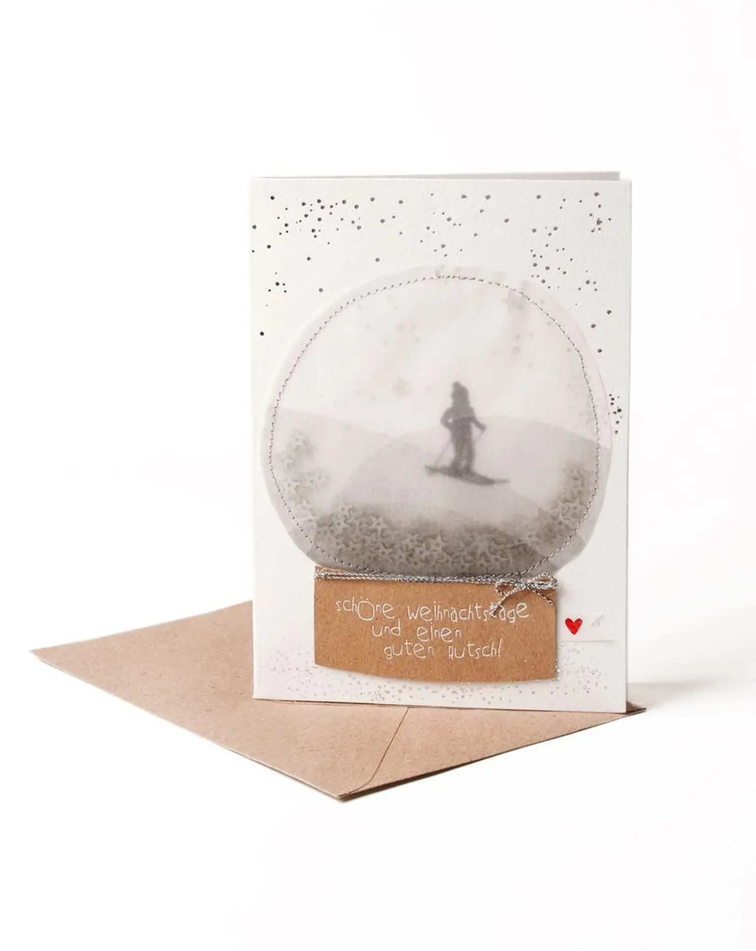 Schneekugelkarte Skifahrer.webp Schneekugelkarte Skifahrer - Weihnachtszauber zum Verschicken
